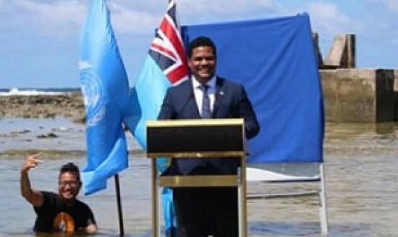 Tuvalu’s Minister for Justice, Communication & Foreign Affairs Simon Kofe gives a COP26 statement while standing in the ocean in Funafuti, Tuvalu November 5, 2021. Tuvalu Foreign Ministry | via Reuters