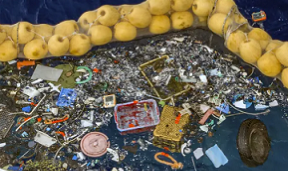 The boom skims up waste ranging in size from a discarded net and a car wheel to tiny chips of plastic. Photo credit: AP