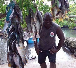 Authorised offier, Mr. John Laket, with some of the fishes landed on Chiefs day. Credit - Glenda Wille, https://dailypost.vu/