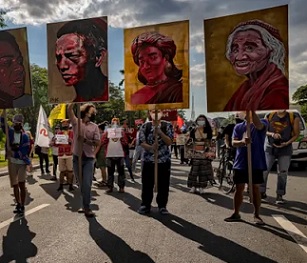 Climate activists hold up portraits of slain Philippine environmental defenders during a climate justice protest last November. Photograph: Ezra Acayan/Getty Images