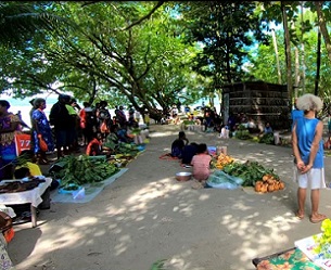 People gather at the local island market. Normally, fishers sell fish at the town market, a 40 minute boat ride from Ahus island. Photo credit: Dean Miller