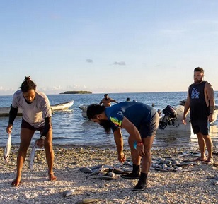 Men sort their catch in Tokelau – bigger families get bigger shares. Photograph: Elena Pasilio