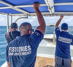 Marshall Islands fisheries officers Beau Bigler and Melvin Silk head across Majuro Lagoon in February 2020 to board and inspect an arriving vessel. Credit - Francisco Blaha.