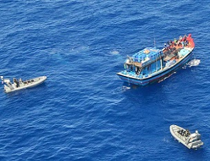 A Vietnamese illegal fishing vessel in the Coral Sea being intercepted by Australian Border Force. Credit - AAP Image/Department of Immigration and Border Protection