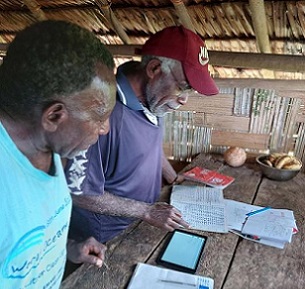 Noel Kaibaba and Philip Vanuau of Bamboo Bay, Malekula entering turtle nest data into Kobo Toolbox, an online smart-phone data collection App, as part of the By-catch and Integrated Ecosystem Management (BIEM) Initiative in Vanuatu. Image: Christopher Bartlett, Resilience