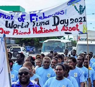 Students of the School of Fisheries and Marine Studies at Solomon Islands National University march under a banner celebrating the worth of tuna during a World Tuna Day parade in Honiara. Photo: Ronald F. Toito’ona.