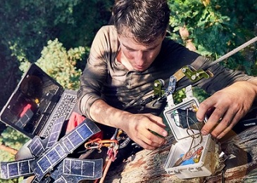 Topher White of Rainforest Connection installing a bioacoustic device in the forest canopy. Image by Ben Von Wong.