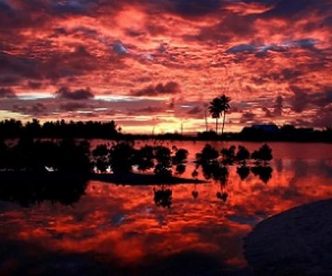 Villagers watch the sunset over a small lagoon near the village of Tangintebu on South Tarawa. The project would involve building the land masses up with sand and gravel. (David Gray/Reuters)