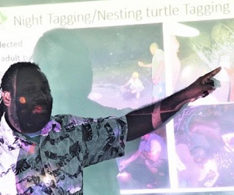 TNC Marine Scientist Simon Peter Vuto explains the work of Rangers at a leatherback turtle workshop. Credit - Ian Kaukui