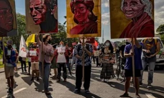 Climate activists hold up portraits of slain Philippine environmental defenders during a climate justice protest last November. Photograph: Ezra Acayan/Getty Images