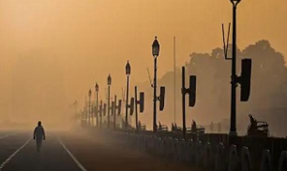 A man walks along Rajpath amid smoggy conditions in New Delhi on January 28, 2021. (Jewel Samad/AFP via Getty Images)
