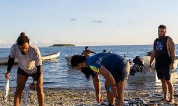 Men sort their catch in Tokelau – bigger families get bigger shares. Photograph: Elena Pasilio