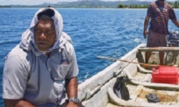  Mosese and Kinikoto collect sea-urchins from the Navakavu Reef, off Fiji’s main island, Viti Levu. The tabu, a traditional marker of fishing grounds, prevents over-fishing. Photograph: Kurt Johnson & Thomas Dallow