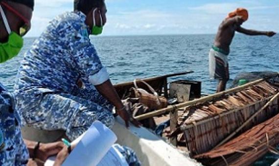 Patrolmen document a violation in a marine reserve in West Papua. Image: Syafri Tuharea, UTPD