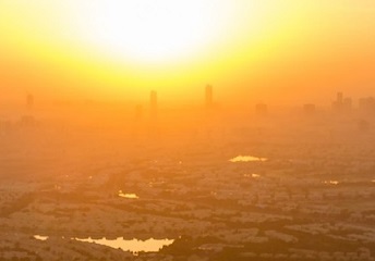 sun sets over a city. source - SHUTTERSTOCK.COM