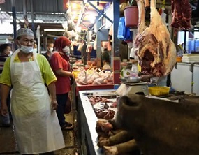 A poultry butcher at a wet market in Kuala Lumpur. Photograph: Vincent Thian/AP